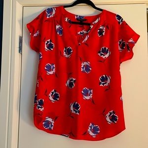 Red top with blue and white floral detail